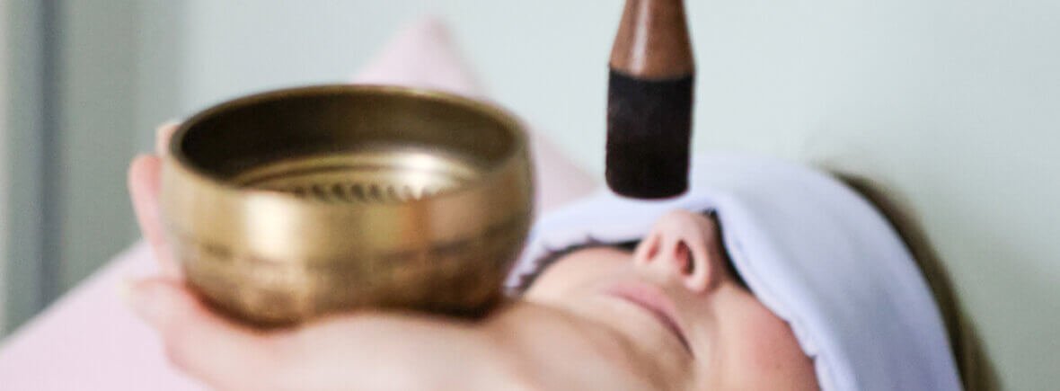 Sophie performing a close-up Reiki energy treatment at Be About Health.